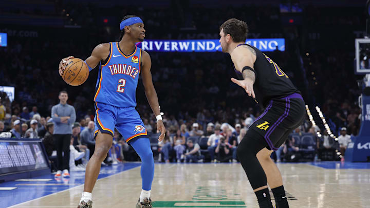 Apr 2, 2026; Oklahoma City, Oklahoma, USA; Oklahoma City Thunder guard Shai Gilgeous-Alexander (2) dribbles down the court as Los Angeles Lakers guard Luka Doncic (77) defends during the second half at Paycom Center. Mandatory Credit: Alonzo Adams-Imagn Images