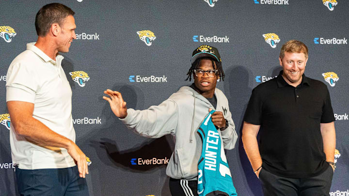 The Jacksonville Jaguars’ first-round pick, Colorado Buffaloes wide receiver and defensive back Travis Hunter, center, throws up the Heisman pose to Tony Boselli, Executive Vice President of Football Operations, left, as Head Coach Liam Coen, right, laughs after a press conference Friday, March 25, 2025 at Miller Electric Center in Jacksonville, Fla.