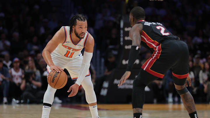 Mar 2, 2025; Miami, Florida, USA; New York Knicks guard Jalen Brunson (11) dribbles the basketball as Miami Heat guard Terry Rozier (2) defends during the first quarter at Kaseya Center. Mandatory Credit: Sam Navarro-Imagn Images