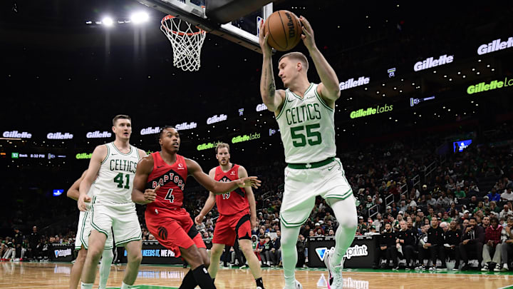 Oct 13, 2024; Boston, Massachusetts, USA;  Boston Celtics forward Baylor Scheierman (55) saves the ball from going out of bounds during the second half against the Toronto Raptors at TD Garden. Mandatory Credit: Bob DeChiara-Imagn Images