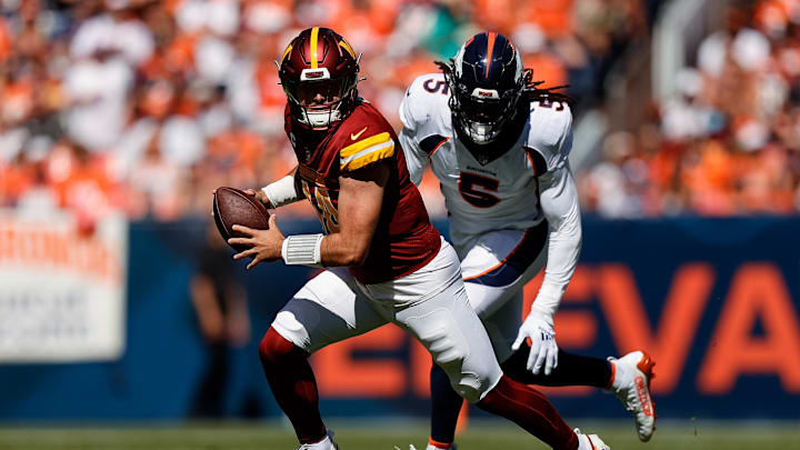 Sep 17, 2023; Denver, Colorado, USA; Washington Commanders quarterback Sam Howell (14) scrambles
