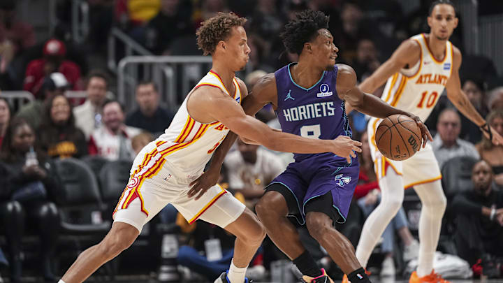 Nov 23, 2025; Atlanta, Georgia, USA; Atlanta Hawks guard Dyson Daniels (5) defends Charlotte Hornets guard Collin Sexton (8) during the first half at State Farm Arena. Mandatory Credit: Dale Zanine-Imagn Images