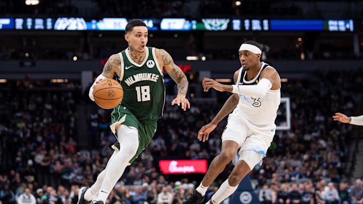 Feb 12, 2025; Minneapolis, Minnesota, USA; Milwaukee Bucks forward Kyle Kuzma (18) dribbles against Minnesota Timberwolves forward Jaden McDaniels (3) in the fourth quarter at Target Center. Mandatory Credit: Brad Rempel-Imagn Images