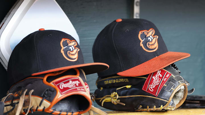 Apr 27, 2023; Detroit, Michigan, USA;  Baltimore Orioles hats and glove sits in dugout in the second inning against the Detroit Tigers at Comerica Park. Mandatory Credit: Rick Osentoski-Imagn Images