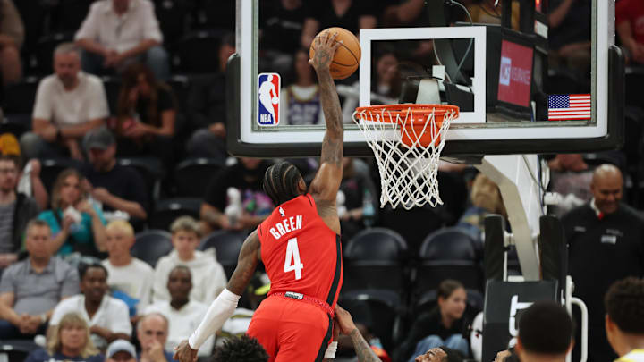Oct 7, 2024; Salt Lake City, Utah, USA; Houston Rockets guard Jalen Green (4) dunks the ball over Utah Jazz forward John Collins (20) during the second quarter at Delta Center. Mandatory Credit: Rob Gray-Imagn Images