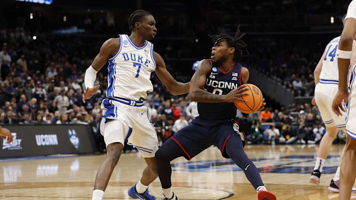 Mar 29, 2026; Washington, DC, USA; UConn Huskies guard Malachi Smith (0) drives to the basket as Duke Blue Devils guard Dame Sarr (7) defends during an Elite Eight game of the East Regional of the men's 2026 NCAA Tournament at Capital One Arena. Mandatory Credit: Geoff Burke-Imagn Images