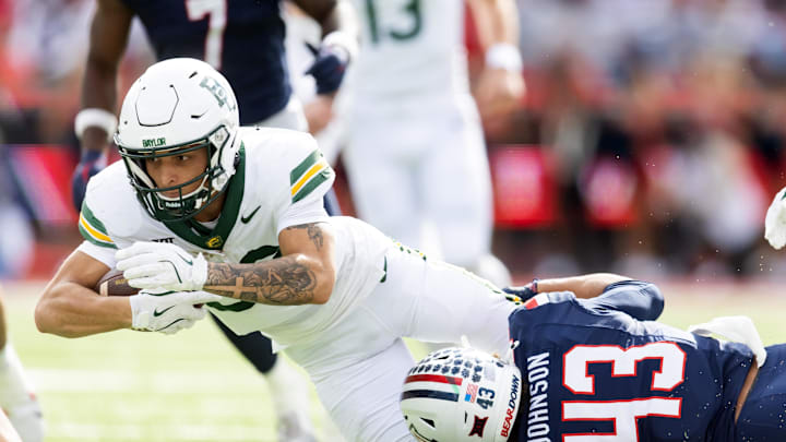 Nov 22, 2025; Tucson, Arizona, USA; Baylor Bears wide receiver Jadon Porter (83) is tackled by Arizona Wildcats defensive back Dalton Johnson (43) in the second half at Casino Del Sol Stadium. Mandatory Credit: Mark J. Rebilas-Imagn Images