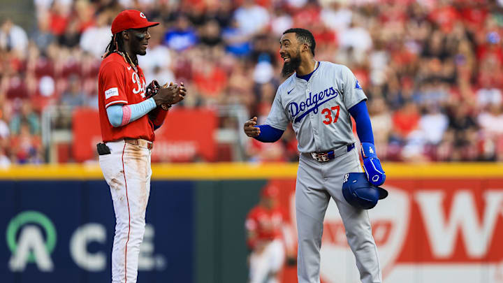 May 25, 2024; Cincinnati, Ohio, USA; Los Angeles Dodgers outfielder Teoscar Hernandez (37) talks with Cincinnati Reds shortstop Elly De La Cruz (44) during a stop in play in the second inning at Great American Ball Park.