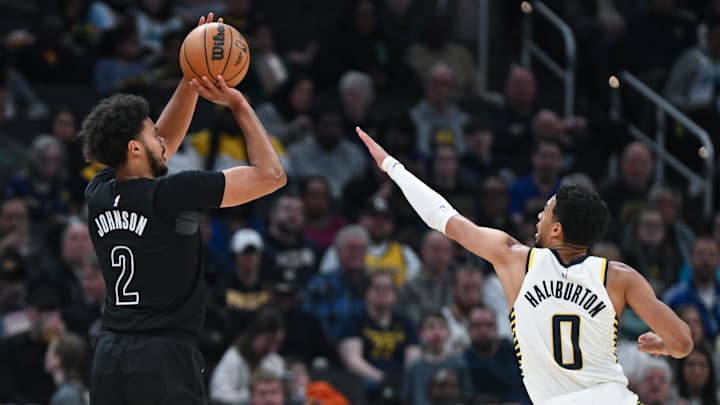 Mar 22, 2025; Indianapolis, Indiana, USA; Brooklyn Nets forward Cameron Johnson (2) makes a three-point basket over Indiana Pacers guard Tyrese Haliburton (0) during the first half at Gainbridge Fieldhouse. Mandatory Credit: Robert Goddin-Imagn Images