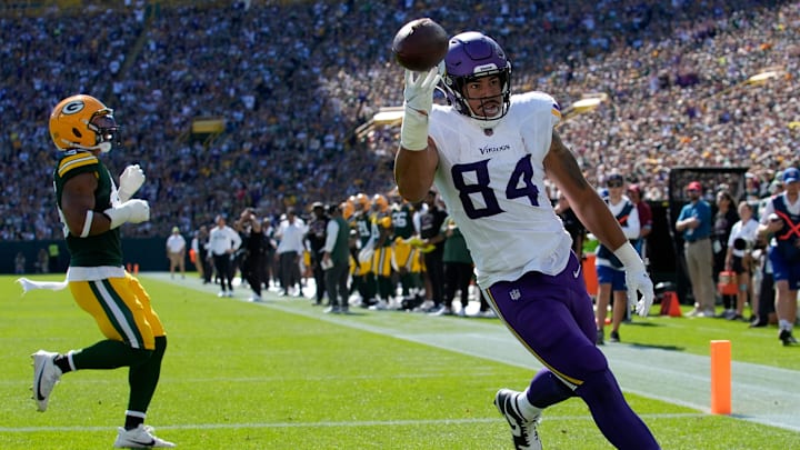 Minnesota Vikings tight end Josh Oliver (84) scores a touchdown during the first quarter of their game against the Green Bay Packers Sunday, September 29, 2024 at Lambeau Field in Green Bay, Wisconsin.