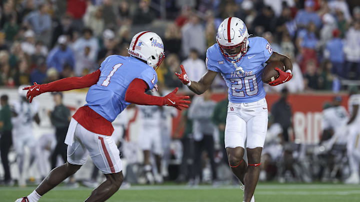 Nov 23, 2024; Houston, Texas, USA; Houston Cougars defensive back Jeremiah Wilson (20) celebrates with defensive back Latrell McCutchin Sr. (1) after an interception during the first quarter against the Baylor Bears at TDECU Stadium. Mandatory Credit: Troy Taormina-Imagn Images
