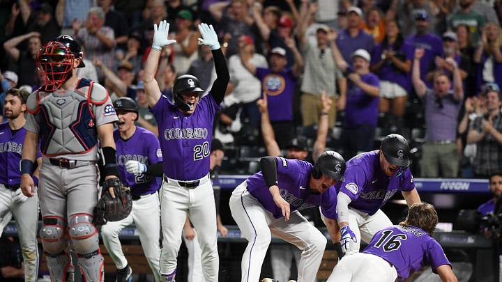Colorado Rockies players celebrating at home plate 