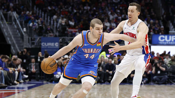 Feb 25, 2026; Detroit, Michigan, USA;  Oklahoma City Thunder guard Nikola Topic (44) dribbles defended by Detroit Pistons forward Duncan Robinson (55) in the second half at Little Caesars Arena. Mandatory Credit: Rick Osentoski-Imagn Images