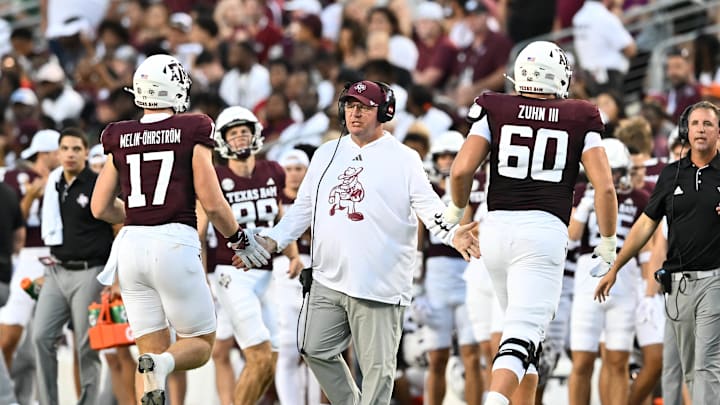 Aug 31, 2024; College Station, Texas, USA; Texas A&M Aggies coach Mike Elko high fives players as they exit the field during the second quarter against the Notre Dame Fighting Irish at Kyle Field.