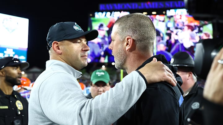 Dec 20, 2024; Tampa, FL, USA; Tulane Green Wave head coach Jon Sumrall and Florida Gators head coach Billy Napier greet after the game at Raymond James Stadium. Mandatory Credit: Kim Klement Neitzel-Imagn Images