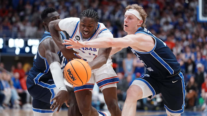 Kansas Jayhawks forward Flory Bidunga (40) goes after a loose ball against BYU Cougars guard Richie Saunders (15) during the game inside Allen Fieldhouse on Jan. 31, 2026.