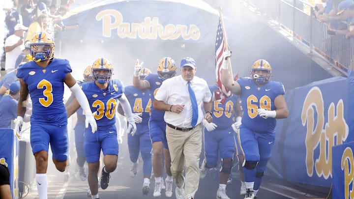 Sep 21, 2024; Pittsburgh, Pennsylvania, USA;  Pittsburgh Panthers defensive back Donovan McMillon (3) and linebacker Brandon George (30) and head coach Pat Narduzzi (tie) and offensive lineman Matt Metrosky (69) take the field to play the Youngstown State Penguins against at Acrisure Stadium. Mandatory Credit: Charles LeClaire-Imagn Images