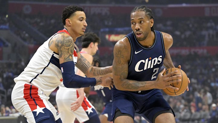 Los Angeles Clippers forward Kawhi Leonard (2) is defended by Washington Wizards forward Kyle Kuzma (33) in the first half at Crypto.com Arena. Mandatory Credit: Jayne Kamin-Oncea-Imagn Images