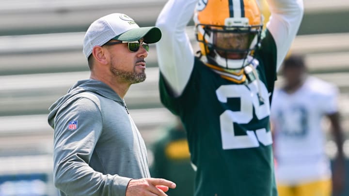 Green Bay Packers coach Matt LaFleur watches minicamp alonside Xavier McKinney at Ray Nitschke Field. 