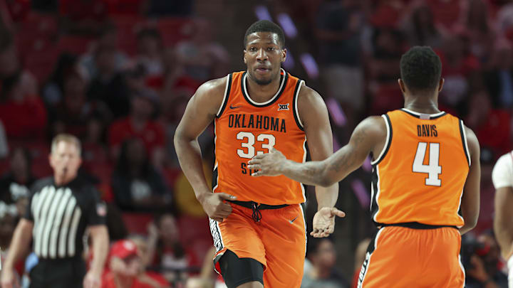 Feb 4, 2025; Houston, Texas, USA; Oklahoma State Cowboys forward Abou Ousmane (33) celebrates with guard Davonte Davis (4) after a play during the first half against the Houston Cougars at Fertitta Center. Mandatory Credit: Troy Taormina-Imagn Images