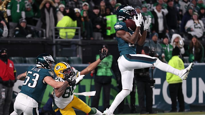 Jan 12, 2025; Philadelphia, Pennsylvania, USA; Philadelphia Eagles cornerback Quinyon Mitchell (27) makes an interception against the Green Bay Packers in an NFC wild card game at Lincoln Financial Field. Mandatory Credit: Bill Streicher-Imagn Images