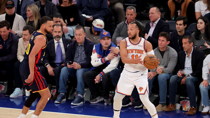 Mar 4, 2025; New York, New York, USA; New York Knicks guard Jalen Brunson (11) looks to pass the ball against Golden State Warriors guard Stephen Curry (30) during the first quarter at Madison Square Garden. Mandatory Credit: Brad Penner-Imagn Images