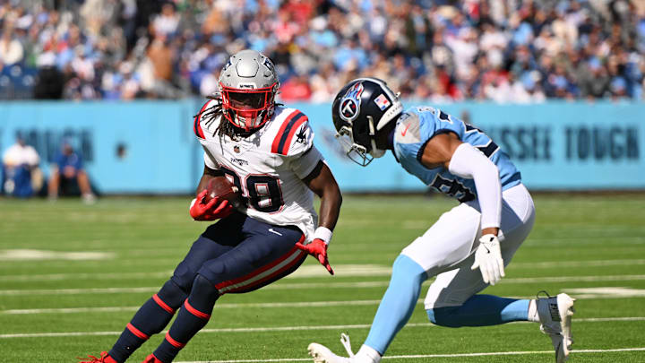 Oct 19, 2025; Nashville, Tennessee, USA; New England Patriots running back Rhamondre Stevenson (38) runs with the ball against Tennessee Titans cornerback Darrell Baker Jr. (39) during the second half at Nissan Stadium. Mandatory Credit: Steve Roberts-Imagn Images Oct 19, 2025; Nashville, Tennessee, USA; New England Patriots running back Rhamondre Stevenson (38) runs with the ball against Tennessee Titans cornerback Darrell Baker Jr. (39) during the second half at Nissan Stadium. Mandatory Credit: Steve Roberts-Imagn Images