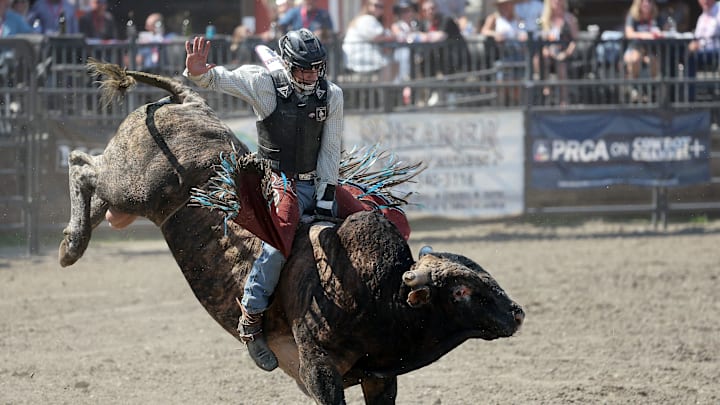 Bull rider Fulton Rutland, of Westlville, OK, rides a bull named Brindle Bob during the PRCA Xtreme Bulls at the Kitsap Stampede in Thunderbird Arena in Bremerton, Wash. on Sunday, Aug. 24, 2025.