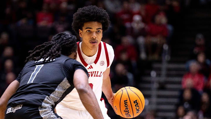 Louisville Cardinals guard Mikel Brown (0) handles the ball as Cincinnati Bearcats guard Day Day Thomas (1) guards him in the first half of the NCAA Basketball game at Heritage Bank Center in Cincinnati on Nov. 21, 2025. Louisville Cardinals guard Mikel Brown (0) handles the ball as Cincinnati Bearcats guard Day Day Thomas (1) guards him in the first half of the NCAA Basketball game at Heritage Bank Center in Cincinnati on Nov. 21, 2025.