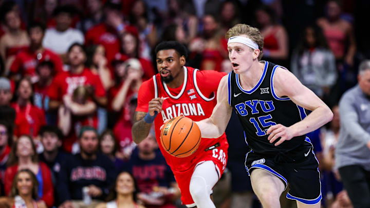 Feb 22, 2025; Tucson, Arizona, USA; BYU Cougars guard Richie Saunders (15) dribbles the ball while Arizona Wildcats guard KJ Lewis (5) follows him during the first half at McKale Center. Mandatory Credit: Aryanna Frank-Imagn Images