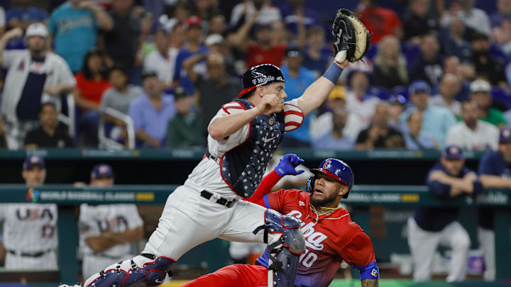 USA catcher Will Smith (16) retires Cuba third baseman Yoan Moncada (10) at home plate during the first inning at LoanDepot Park in 2023.