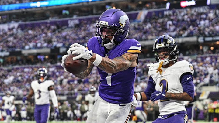 Nov 9, 2025; Minneapolis, Minnesota, USA; Minnesota Vikings wide receiver Jalen Nailor (1) scores on a touchdown pass as Baltimore Ravens cornerback Nate Wiggins (2) defends during the fourth quarter at U.S. Bank Stadium. Mandatory Credit: Jeffrey Becker-Imagn Images