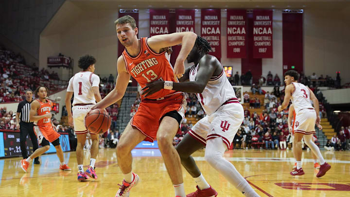 Jan 14, 2025; Bloomington, Indiana, USA; Illinois Fighting Illini center Tomislav Ivisic (13) goes to the basket against Indiana Hoosiers center Oumar Ballo (11) during the second half at Simon Skjodt Assembly Hall. Mandatory Credit: Robert Goddin-Imagn Images