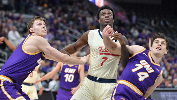Northern Iowa guard Ben Schwieger (7) and Tristan Smith (14) wrestle for position with UIC forward Abdul Momoh in the Missouri Valley tournament championship game.