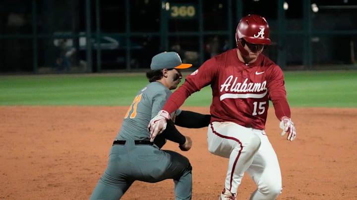 Mar 20, 2025; Tuscaloosa AL, USA; Alabama outfielder Coleman Mizell (15) barely gets back safely as Tennessee infielder Andrew Fischer (11) takes a pickoff throw from Tennessee pitcher Liam Doyle (12) at Sewell-Thomas Stadium.
