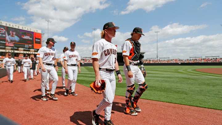 Oklahoma State pitcher Brian Holiday, left, and catcher Charlie Carter walk on the field before a Bedlam baseball game between the Oklahoma State Cowboys (OSU) and the Oklahoma Sooners (OU) in Stillwater, Okla., Saturday, April 6, 2024. Oklahoma State pitcher Brian Holiday, left, and catcher Charlie Carter walk on the field before a Bedlam baseball game between the Oklahoma State Cowboys (OSU) and the Oklahoma Sooners (OU) in Stillwater, Okla., Saturday, April 6, 2024.