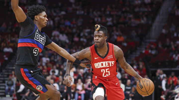Jan 1, 2024; Houston, Texas, USA; Houston Rockets forward Reggie Bullock Jr. (25) controls the ball as Detroit Pistons forward Ausar Thompson (9) defends during the game at Toyota Center. Mandatory Credit: Troy Taormina-USA TODAY Sports
