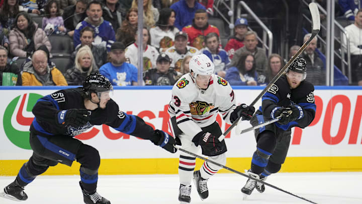 Dec 2, 2024; Toronto, Ontario, CAN; Toronto Maple Leafs defenseman Philippe Myers (51) and forward Alexander Nylander (92) defend against Chicago Blackhawks forward Lukas Reichel (73) during the second period at Scotiabank Arena. Mandatory Credit: John E. Sokolowski-Imagn Images