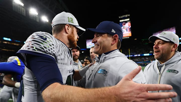 Dec 18, 2025; Seattle, Washington, USA; Seattle Seahawks head coach Mike MacDonald embraces quarterback Sam Darnold (14) after defeating the Los Angeles Rams in overtime at Lumen Field. Mandatory Credit: Kevin Ng-Imagn Images
