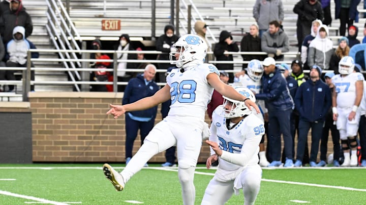 Nov 23, 2024; Chestnut Hill, Massachusetts, USA;  North Carolina Tar Heels place kicker Noah Burnette (98) kicks an extra point against the Boston College Eagles during the second half at Alumni Stadium. 