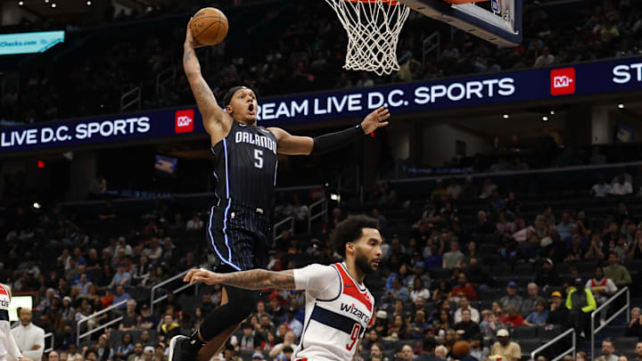 Apr 3, 2025; Washington, District of Columbia, USA; Orlando Magic forward Paolo Banchero (5) dunks the ball as Washington Wizards forward Justin Champagnie (9) defends in the first half at Capital One Arena. Mandatory Credit: Geoff Burke-Imagn Images