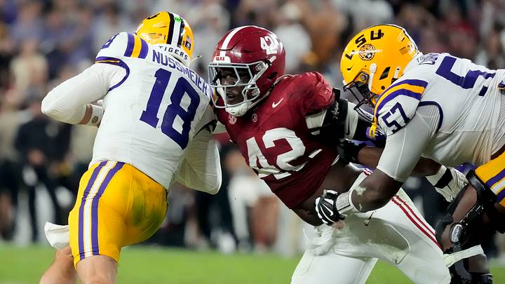 Nov 8, 2025; Tuscaloosa, Alabama, USA; Alabama linebacker Yhonzae Pierre (42) fights off a block by LSU offensive lineman Carius Curne (57) to sack LSU quarterback Garrett Nussmeier (18) for a loss at Saban Field at Bryant-Denny Stadium. Alabama defeated LSU 20-9. Mandatory Credit: Gary Cosby Jr.-Imagn Images Nov 8, 2025; Tuscaloosa, Alabama, USA; Alabama linebacker Yhonzae Pierre (42) fights off a block by LSU offensive lineman Carius Curne (57) to sack LSU quarterback Garrett Nussmeier (18) for a loss at Saban Field at Bryant-Denny Stadium. Alabama defeated LSU 20-9. Mandatory Credit: Gary Cosby Jr.-Imagn Images