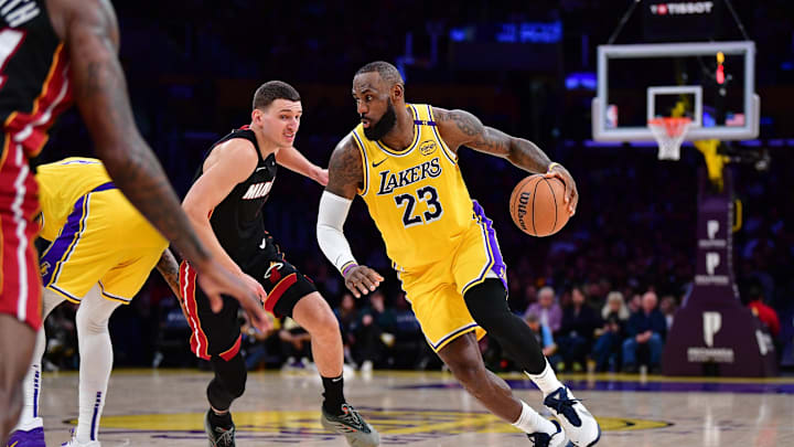 January 15, 2025; Los Angeles, California, USA; Los Angeles Lakers forward LeBron James (23) moves the ball against Miami Heat guard Tyler Herro (14) during the second half at Crypto.com Arena. Mandatory Credit: Gary A. Vasquez-Imagn Images