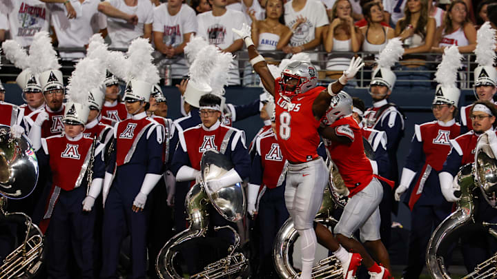 Aug 31, 2024; Tucson, Arizona, USA; New Mexico Lobos safety Christian Ellis (8) celebrates deflecting a catch in front of Arizona Wildcats band The Pride of Arizona during second quarter at Arizona Stadium. Mandatory Credit: Aryanna Frank-Imagn Images