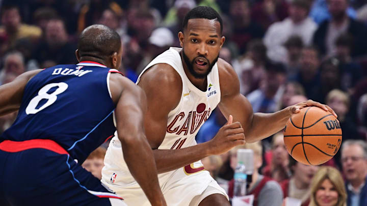 Mar 30, 2025; Cleveland, Ohio, USA; Cleveland Cavaliers forward Evan Mobley (4) drives to the basket against Los Angeles Clippers guard Kris Dunn (8) during the first quarter at Rocket Arena. Mandatory Credit: Ken Blaze-Imagn Images

