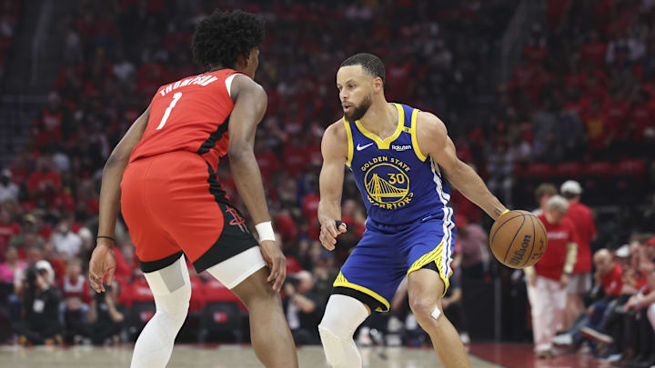 Apr 20, 2025; Houston, Texas, USA; Golden State Warriors guard Stephen Curry (30) controls the ball as Houston Rockets forward Amen Thompson (1) defends during the first quarter at Toyota Center. Mandatory Credit: Troy Taormina-Imagn Images