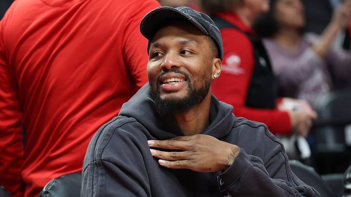 Oct 10, 2025; Portland, Oregon, USA; Portland Trail Blazers guard Damian Lillard (0) smiles while sitting on the bench before the Trail Blazers plays Sacramento Kings at Moda Center. Mandatory Credit: Jaime Valdez-Imagn Images Oct 10, 2025; Portland, Oregon, USA; Portland Trail Blazers guard Damian Lillard (0) smiles while sitting on the bench before the Trail Blazers plays Sacramento Kings at Moda Center. Mandatory Credit: Jaime Valdez-Imagn Images