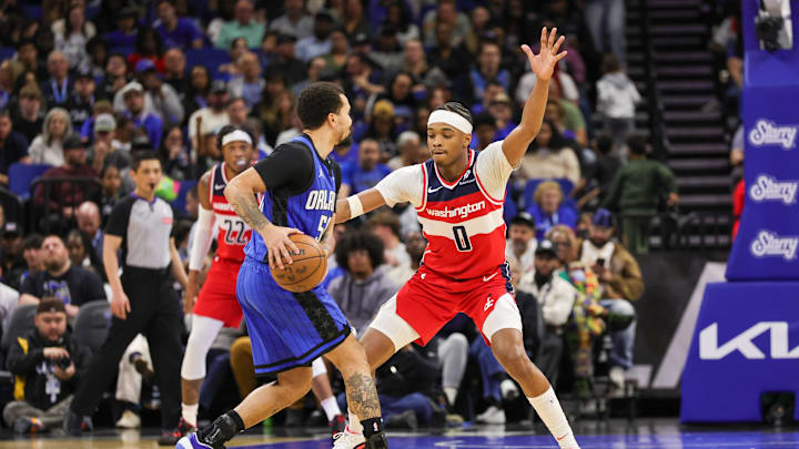 Feb 23, 2025; Orlando, Florida, USA; Washington Wizards guard Bilal Coulibaly (0) defends Orlando Magic guard Cole Anthony (50) during the second quarter at Kia Center. Mandatory Credit: Mike Watters-Imagn Images
