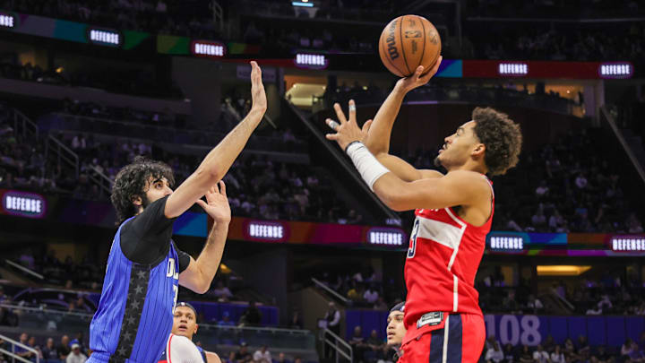 Feb 23, 2025; Orlando, Florida, USA; Washington Wizards guard Jordan Poole (13) shoots against Orlando Magic center Goga Bitadze (35) during the second quarter at Kia Center. Mandatory Credit: Mike Watters-Imagn Images