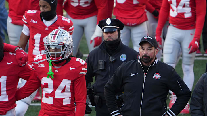 Ohio State University football coach Ryan Day tries to join the team to sing Carmen Ohio after the Michigan game Saturday, November 30, 2024 in Ohio Stadium. As he was standing here, the melee was starting behind him as Michigan players tried to plant a flag at midfield.
